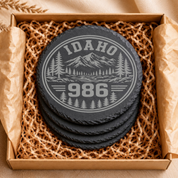 Idaho Area Code Slate Coasters | 208 & 986 Rustic Idaho Gifts | Engraved Mountain Cabin Stone Coasters — Dandelion Design Co. — SlateStudioMedia:gallery:7 — 0098-IAGN_idaho_area_code_slate_coasters_208_986_rustic_idaho_gifts_engraved_mountain_cabin_stone_coasters_06_round_gift_box.png