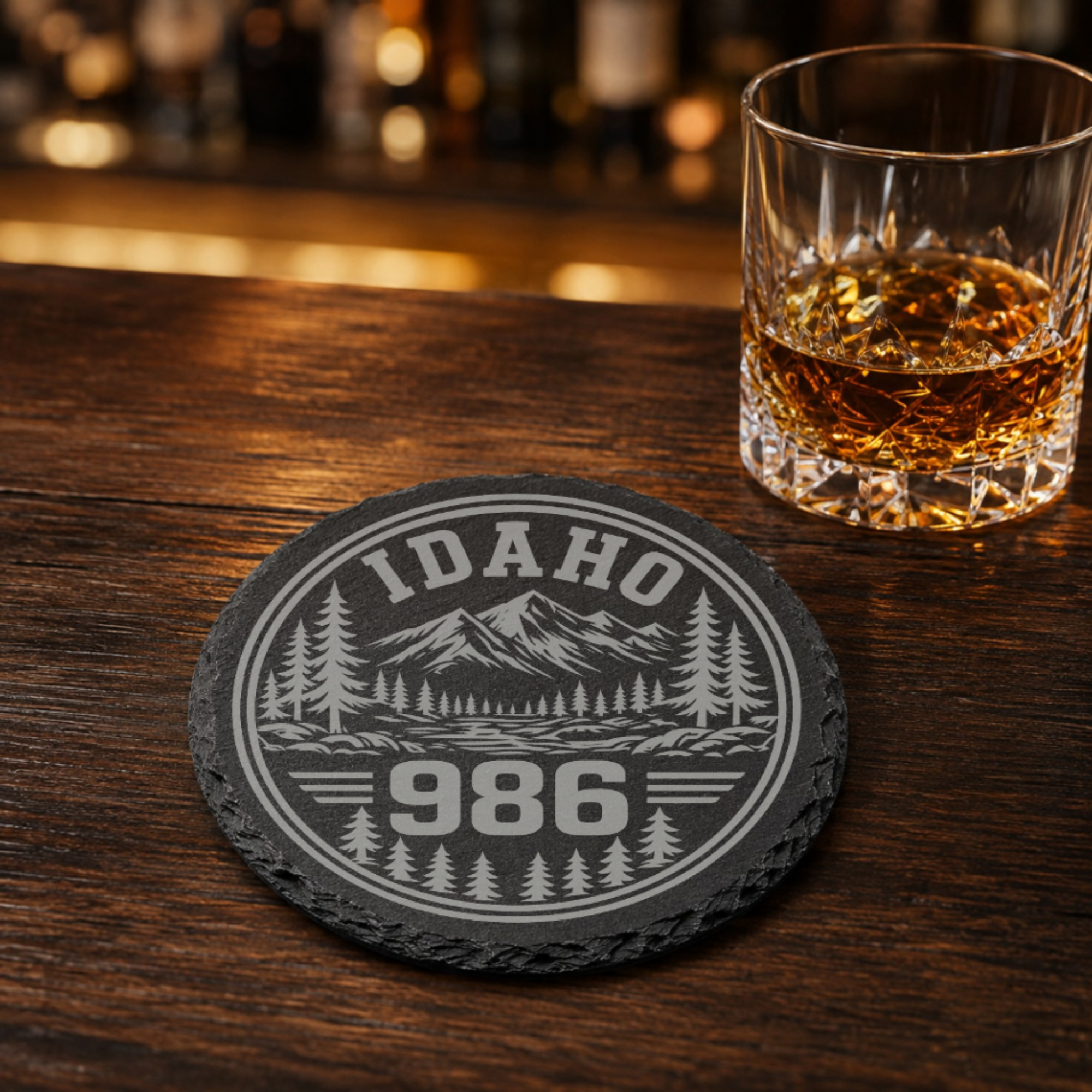 Idaho Area Code Slate Coasters | 208 & 986 Rustic Idaho Gifts | Engraved Mountain Cabin Stone Coasters — Dandelion Design Co. — SlateStudioMedia:gallery:13 — 0098-IAGN_idaho_area_code_slate_coasters_208_986_rustic_idaho_gifts_engraved_mountain_cabin_stone_coasters_08_round_whiskey_lifestyle.png