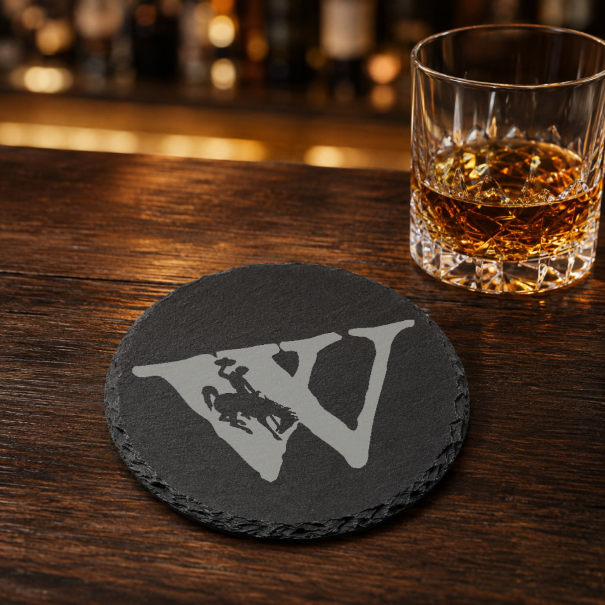Wyoming Bucking Horse Slate Coaster Set | Set of 4 Steamboat EngravedSlate Coaster Set | Wyoming Cowboys | Drink Coaster | Table Decor — Dandelion Design Co. — SlateStudioMedia:gallery:9 — 0100-WBGN_wyoming_bucking_horse_slate_coaster_set_set_of_4_steamboat_engravedslate_coaster_set_wyoming_cowboys_drink_coaster_table_decor_08_round_whiskey_lifestyle.png
