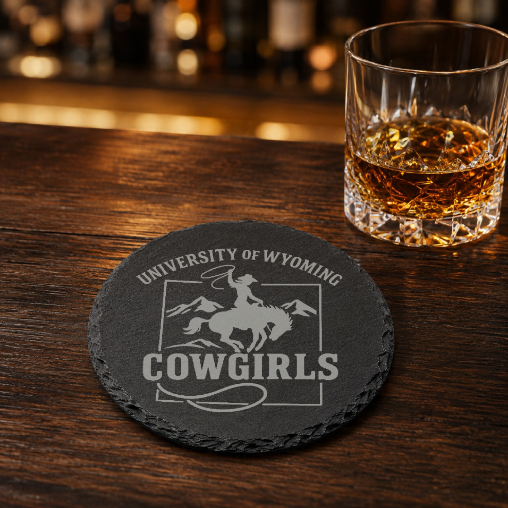 University of Wyoming Slate Coaster – "The World Needs More Cowboys" | Laser Engraved | Rustic Cowboy Gift - UW — Dandelion Design Co. — SlateStudioMedia:gallery:13 — 0101-UWGN_university_of_wyoming_slate_coaster_quot_the_world_needs_more_cowboys_quot_laser_engraved_rustic_cowboy_gift_uw_08_round_whiskey_lifestyle.png