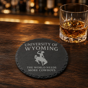 University of Wyoming Slate Coaster – "The World Needs More Cowboys" | Laser Engraved | Rustic Cowboy Gift - UW — Dandelion Design Co. — SlateStudioMedia:gallery:15 — 0101-UWGN_university_of_wyoming_slate_coaster_quot_the_world_needs_more_cowboys_quot_laser_engraved_rustic_cowboy_gift_uw_16_D02_round_whiskey_lifestyle.png
