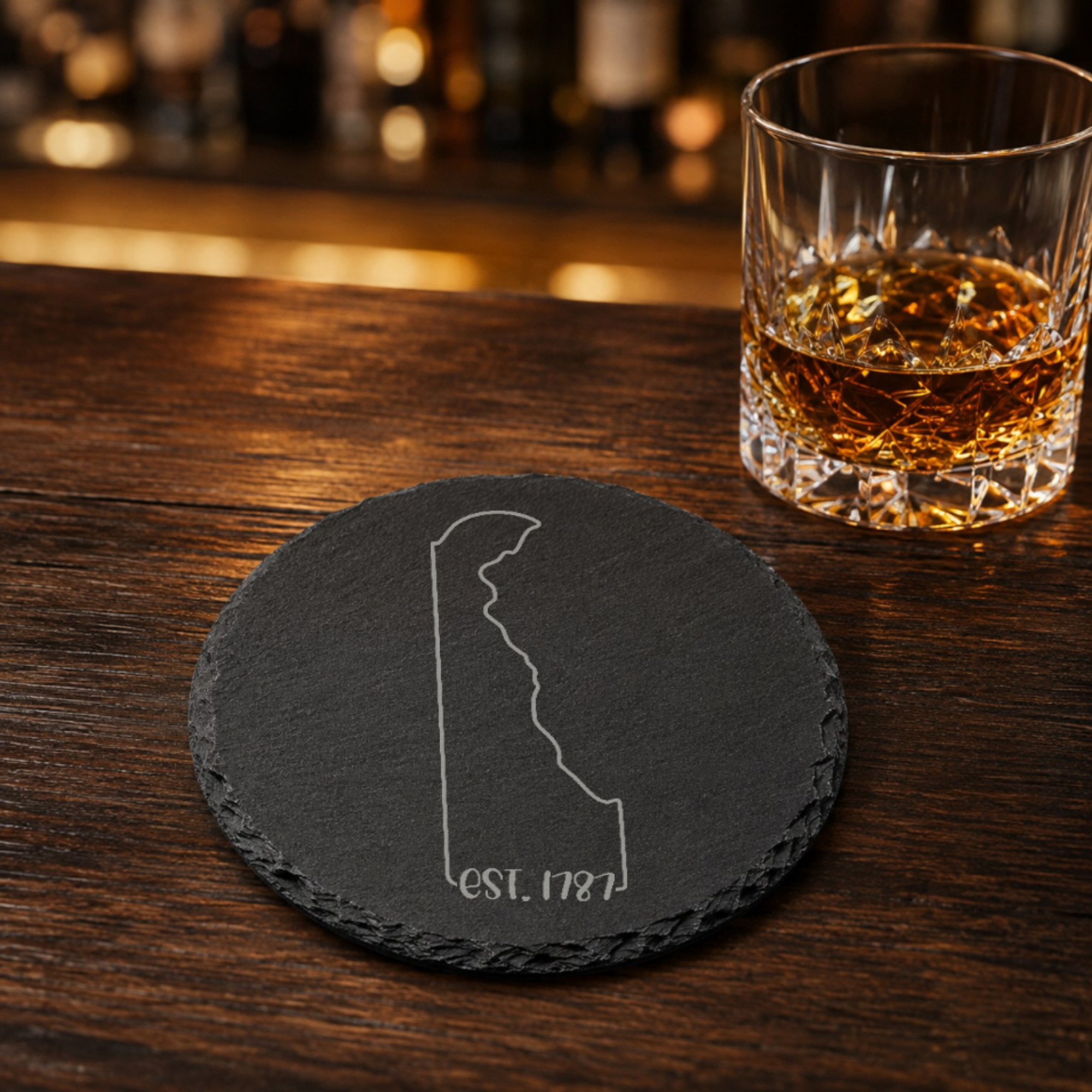 Delaware Slate Coasters 4x4 Laser Engraved Stone Drink Coasters Delaware Home Décor First State Established 1787 Gift — Dandelion Design Co. — SlateStudioMedia:gallery:21 — 0104-DSGN_delaware_slate_coasters_4x4_laser_engraved_stone_drink_coasters_delaware_home_d_cor_first_state_established_1787_gift_22_D03_round_whiskey_lifestyle.png