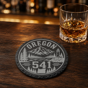 Oregon Area Code Slate Coasters | 503 971 541 458 Oregon Gift | Engraved Rustic Stone Coaster | Pacific Northwest Cabin Decor — Dandelion Design Co. — SlateStudioMedia:gallery:21 — 0104-OAGN_oregon_area_code_slate_coasters_503_971_541_458_oregon_gift_engraved_rustic_stone_coaster_pacific_northwest_cabin_decor_08_round_whiskey_lifestyle.png