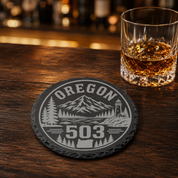 Oregon Area Code Slate Coasters | 503 971 541 458 Oregon Gift | Engraved Rustic Stone Coaster | Pacific Northwest Cabin Decor — Dandelion Design Co. — SlateStudioMedia:gallery:27 — 0104-OAGN_oregon_area_code_slate_coasters_503_971_541_458_oregon_gift_engraved_rustic_stone_coaster_pacific_northwest_cabin_decor_28_D04_round_whiskey_lifestyle.png