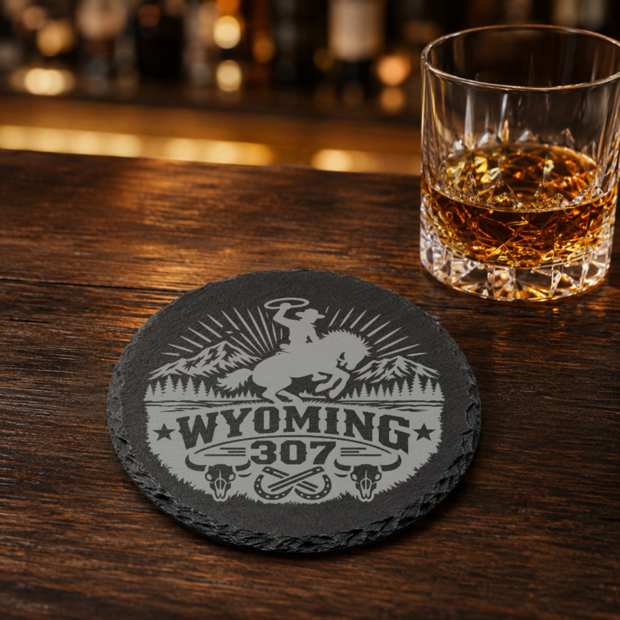Wyoming 307 Engraved Slate Coaster SetEngraved Slate Coaster Set | Wyoming Cowboys | Drink Coaster | Table Decor — Dandelion Design Co. — SlateStudioMedia:gallery:9 — 0105-W3GN_wyoming_307_engraved_slate_coaster_setengraved_slate_coaster_set_wyoming_cowboys_drink_coaster_table_decor_08_round_whiskey_lifestyle.png