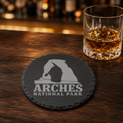 Arches National Park Slate Coaster – Natural Stone Drink Coaster with Trees | Rustic Home Decor | Gift for National Parks — Dandelion Design Co. — SlateStudioMedia:gallery:9 — 0109-ANGN_arches_national_park_slate_coaster_natural_stone_drink_coaster_with_trees_rustic_home_decor_gift_for_national_parks_08_round_whiskey_lifestyle.png