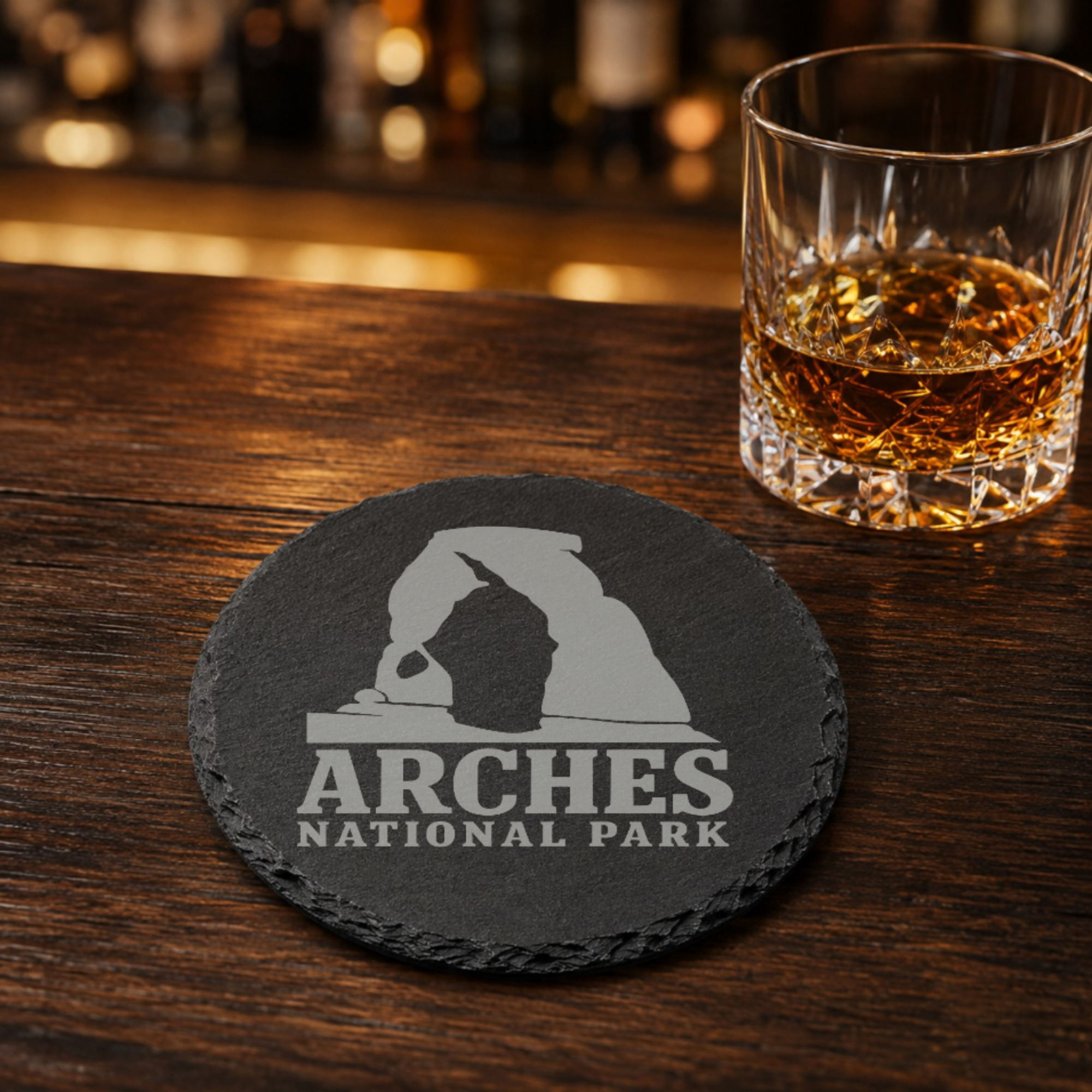 Arches National Park Slate Coaster – Natural Stone Drink Coaster with Trees | Rustic Home Decor | Gift for National Parks — Dandelion Design Co. — SlateStudioMedia:gallery:9 — 0109-ANGN_arches_national_park_slate_coaster_natural_stone_drink_coaster_with_trees_rustic_home_decor_gift_for_national_parks_08_round_whiskey_lifestyle.png