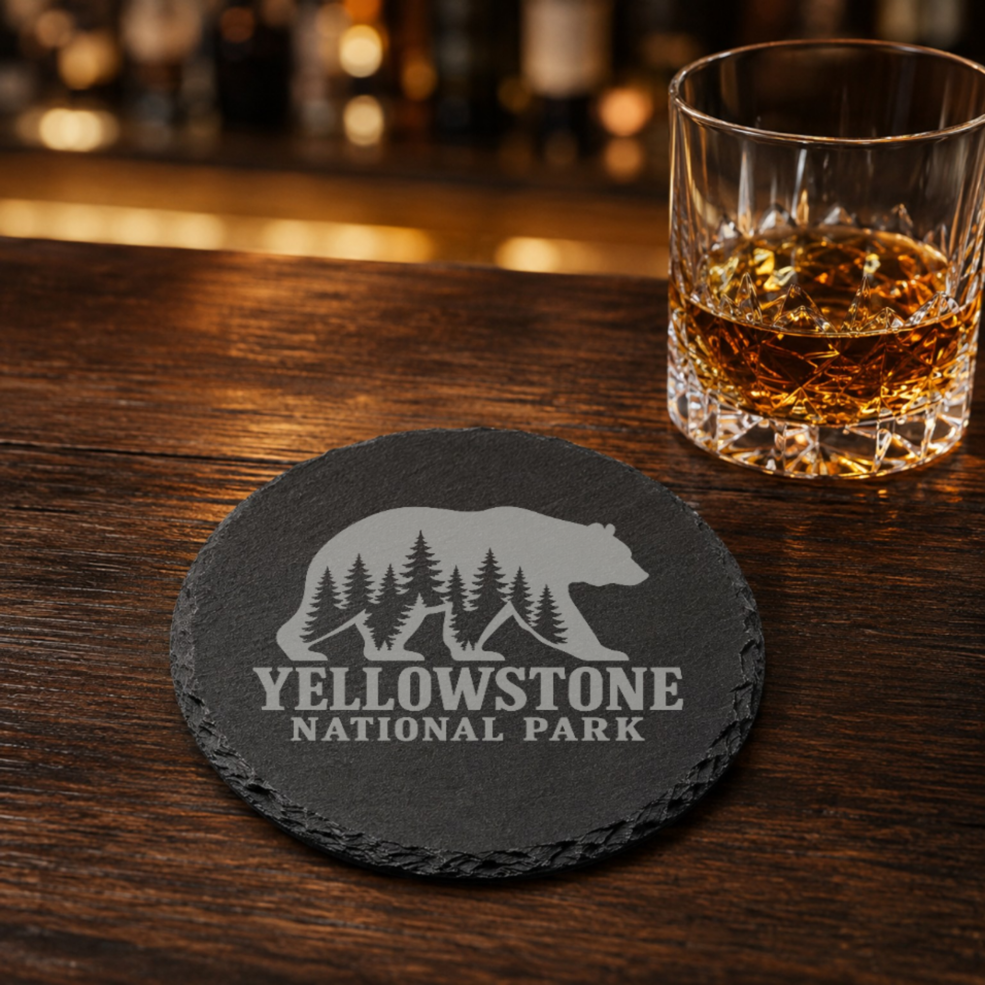 Yellowstone National Park Slate Coaster – Natural Stone Drink Coaster with Bear and Trees | Rustic Home Decor | Gift for National Parks — Dandelion Design Co. — SlateStudioMedia:gallery:9 — 0111-YNGN_yellowstone_national_park_slate_coaster_natural_stone_drink_coaster_with_bear_and_trees_rustic_home_decor_gift_for_national_parks_08_round_whiskey_lifestyle.png