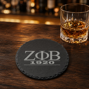 Zeta Phi Beta Sorority Slate Coasters • ZΦB Gift • Founder’s Day Gift • Devastating Diva Gift • Zeta Home Decor • Greek Life Sorority Gift — Dandelion Design Co. — SlateStudioMedia:gallery:29 — 0115-ZPGN_zeta_phi_beta_sorority_slate_coasters_z_b_gift_founder_s_day_gift_devastating_diva_gift_zeta_home_decor_greek_life_sorority_gift_22_D03_round_whiskey_lifestyle.png